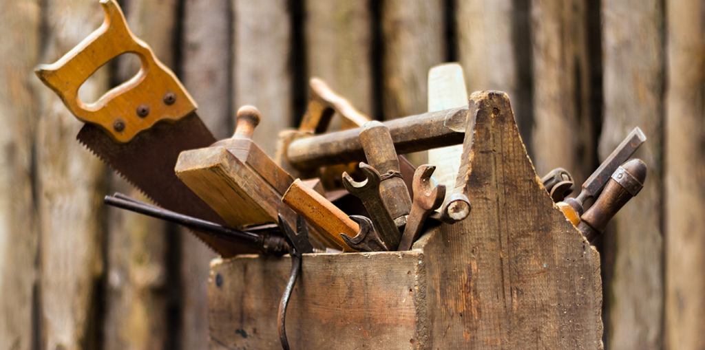 Image of a wodden toobox filled with tools